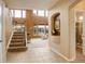 Bright entryway featuring tile flooring, a staircase, and large windows for natural light at 10253 Fairgate Way, Highlands Ranch, CO 80126