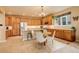 Large kitchen with wood cabinets, granite counters and an eat-in island at 10253 Fairgate Way, Highlands Ranch, CO 80126