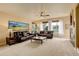 Bright living room featuring comfortable leather sofas, large windows, and neutral tones at 10253 Fairgate Way, Highlands Ranch, CO 80126