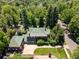Expansive aerial view of home featuring lush landscaping, a green tile roof, and a spacious driveway at 2215 E 7Th Avenue Pkwy, Denver, CO 80206