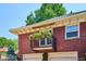 Charming balcony with hanging flower baskets above garage doors and red brick building at 2215 E 7Th Avenue Pkwy, Denver, CO 80206