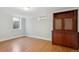 Basement area with wood floors, built-in cabinet, and two windows to bring in natural light at 2215 E 7Th Avenue Pkwy, Denver, CO 80206