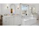 Bright bathroom with marble counters, soaking tub, and elegant fixtures offering a spa-like retreat at 2215 E 7Th Avenue Pkwy, Denver, CO 80206