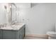 Bathroom with marble vanity, vintage faucets, decorative lighting, and tile floors at 2215 E 7Th Avenue Pkwy, Denver, CO 80206