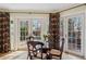 Charming breakfast nook with glass-topped table and views of the landscaped backyard at 2215 E 7Th Avenue Pkwy, Denver, CO 80206