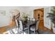 Open dining room with wood floors and a dark wood table connects to the home's kitchen and staircase at 2215 E 7Th Avenue Pkwy, Denver, CO 80206