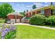 Beautiful brick home with a green tile roof, a two car garage, and a well-manicured lawn at 2215 E 7Th Avenue Pkwy, Denver, CO 80206