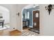 Welcoming foyer featuring a wooden door, hardwood floors, archways, and decorative wall sconces at 2215 E 7Th Avenue Pkwy, Denver, CO 80206