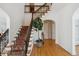Grand foyer with staircase featuring an ornate railing, decorative runner, and hardwood flooring at 2215 E 7Th Avenue Pkwy, Denver, CO 80206