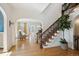 Open foyer with hardwood floors, curved staircase with decorative iron railing, and views into the elegant living spaces at 2215 E 7Th Avenue Pkwy, Denver, CO 80206