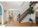Charming foyer with hardwood floors, staircase with carpet runner, and access to the formal living room at 2215 E 7Th Avenue Pkwy, Denver, CO 80206