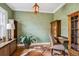 A dedicated home office space is decorated with a brown and white cowhide rug and green patterned wallpaper at 2215 E 7Th Avenue Pkwy, Denver, CO 80206