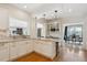 Gourmet kitchen with white cabinets, granite counters, bar stool seating, and open flow to the dining room at 2215 E 7Th Avenue Pkwy, Denver, CO 80206