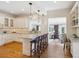 Spacious kitchen with white cabinets, granite countertops, island seating, and open access to the living area at 2215 E 7Th Avenue Pkwy, Denver, CO 80206