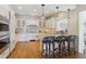 Bright white kitchen features an island with barstool seating, a tile backsplash, and modern stainless steel appliances at 2215 E 7Th Avenue Pkwy, Denver, CO 80206