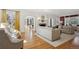 Bright living room featuring hardwood floors, neutral decor, fireplace, and large windows with views at 2215 E 7Th Avenue Pkwy, Denver, CO 80206