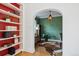 Stylish office featuring bold wallpaper, bright red built-in shelves, and hardwood flooring at 2215 E 7Th Avenue Pkwy, Denver, CO 80206