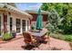 Outdoor patio with brick, featuring a table and chairs, with surrounding greenery at 2215 E 7Th Avenue Pkwy, Denver, CO 80206