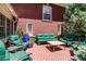 Cozy patio with brick paving, green cushioned furniture, and lush greenery surrounding the space at 2215 E 7Th Avenue Pkwy, Denver, CO 80206