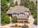 Aerial view of a two-story home featuring mature landscaping, a concrete driveway, and a complex roof line at 9880 E Progress Cir, Greenwood Village, CO 80111