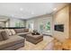 Basement living room featuring a fireplace, neutral furnishings and walk-out access at 9880 E Progress Cir, Greenwood Village, CO 80111
