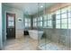 Bathroom featuring a free standing tub, glass enclosed shower, and lots of light at 9880 E Progress Cir, Greenwood Village, CO 80111