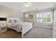 Bedroom featuring neutral paint, a ceiling fan, and a large window at 9880 E Progress Cir, Greenwood Village, CO 80111