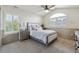 Bedroom with neutral paint, a ceiling fan, and a large window at 9880 E Progress Cir, Greenwood Village, CO 80111