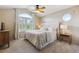 Bedroom with large window and window seat; ceiling fan at 9880 E Progress Cir, Greenwood Village, CO 80111