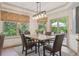 Bright breakfast nook with backyard views, a modern light fixture, and patio access at 9880 E Progress Cir, Greenwood Village, CO 80111
