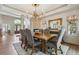 Elegant dining room with a chandelier, fireplace, and an ornate mirror for sophisticated entertaining at 9880 E Progress Cir, Greenwood Village, CO 80111