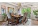 Formal dining room with a chandelier, large windows with outdoor views, and a rustic wooden table at 9880 E Progress Cir, Greenwood Village, CO 80111