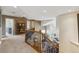 Upstairs hallway featuring iron-and-wood banister, open floorplan, and recessed lighting at 9880 E Progress Cir, Greenwood Village, CO 80111