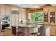 Well-lit kitchen featuring stainless steel appliances, granite counters, and a breakfast bar at 9880 E Progress Cir, Greenwood Village, CO 80111