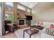 Relaxing living room with a stone fireplace and comfortable seating, perfect for Gathering gatherings at 9880 E Progress Cir, Greenwood Village, CO 80111