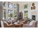 Bright living room with high ceilings, multiple windows, comfortable seating, and a cozy fireplace at 9880 E Progress Cir, Greenwood Village, CO 80111