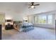 A bright main bedroom with many windows, a ceiling fan, and neutral décor at 9880 E Progress Cir, Greenwood Village, CO 80111