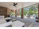 Covered patio with brick pillars, ceiling fan, and comfortable seating area at 9880 E Progress Cir, Greenwood Village, CO 80111