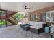 Covered patio with brick pillars and an outdoor seating area with a ceiling fan at 9880 E Progress Cir, Greenwood Village, CO 80111