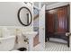 Charming powder room with pedestal sink, unique tile flooring, and elegant decor at 9880 E Progress Cir, Greenwood Village, CO 80111