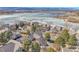 Picturesque neighborhood adjacent to a partially frozen lake with views of the surrounding mountains under a blue sky at 2032 W Nantucket Ct, Littleton, CO 80120