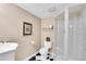 Bathroom featuring a glass-enclosed shower and black and white tile floors at 2032 W Nantucket Ct, Littleton, CO 80120