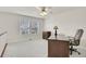 Inviting bedroom space with a large desk, chair, and a view from the two windows at 2032 W Nantucket Ct, Littleton, CO 80120