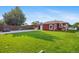 Back exterior showcases a concrete patio, grass, and wooden fence at 11192 E 7Th Ave, Aurora, CO 80010