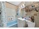Functional full bathroom with a shower-tub combo, vanity, and well-organized shelving at 11192 E 7Th Ave, Aurora, CO 80010