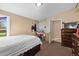 Cozy bedroom showcases a double bed, dresser, and easy access to a tiled bathroom at 11192 E 7Th Ave, Aurora, CO 80010