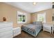 Comfortable bedroom features a bed, two windows, and and dressers at 11192 E 7Th Ave, Aurora, CO 80010