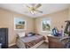 This bedroom features a ceiling fan, two windows, and a dresser with workspace at 11192 E 7Th Ave, Aurora, CO 80010
