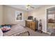 Cozy bedroom includes a window, dresser, television, and doorway to the rest of the home at 11192 E 7Th Ave, Aurora, CO 80010