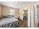 This bedroom showcases a bed, dresser, workspace, closet, and entryway at 11192 E 7Th Ave, Aurora, CO 80010